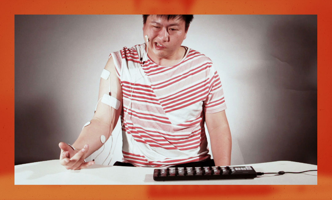 Ka Fai using electrical nerve stimulation on himself to choreograph movement for his project, 'Prospectus For a Future Body' (2010).
